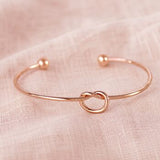 Minimalist rose gold friendship knot bangle with polished finish, elegant stacking jewellery for everyday styling.