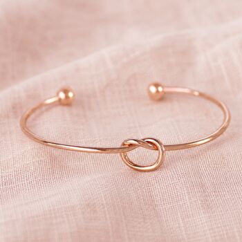 Minimalist rose gold friendship knot bangle with polished finish, elegant stacking jewellery for everyday styling.