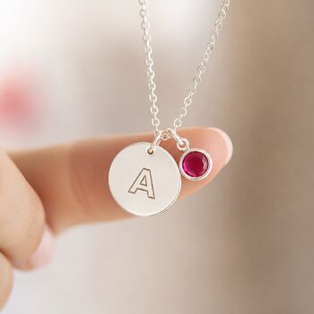 Close-up of a silver plated modern initial necklace with a vibrant birthstone charm for effortless everyday style