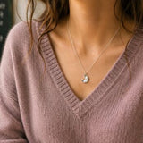 Silver pencil shaving pendant necklace styled with lilac knitwear, quirky everyday jewellery on fine chain
