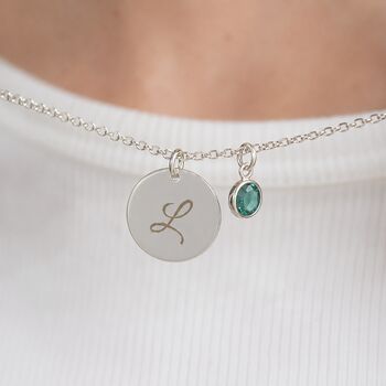 Silver plated script initial disc necklace with a teal birthstone charm, a timeless personalised everyday necklace