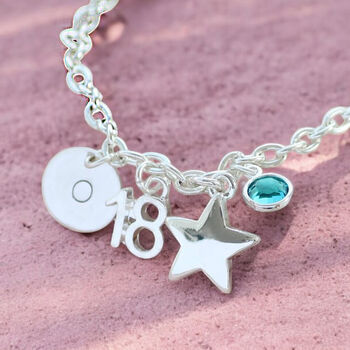 Silver birthday charm bracelet with number pendant, star charm and aqua blue birthstone accent