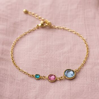 Gold birthstone bracelet featuring aqua, pink and blue crystals on a delicate adjustable chain