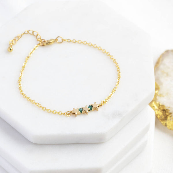 Image shows 30th Birthday Triple Star Birthstone Bracelet with May emerald birthstone on a white backdrop.