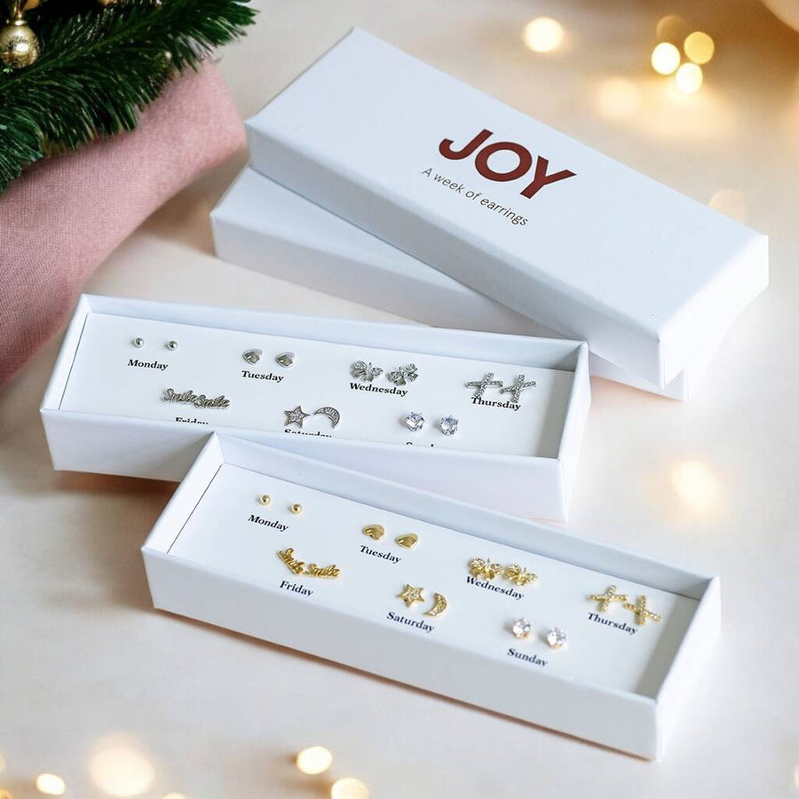 A box of seven pairs of earrings shown in silver and gold colour ways.