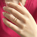 Image shows model wearings a gold plated adjustable double band dotted ring