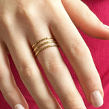 Image shows model wearing a gold triple band adjustable ring