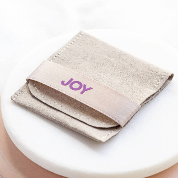 Image shows joy by corrine smith branded suedette pouch