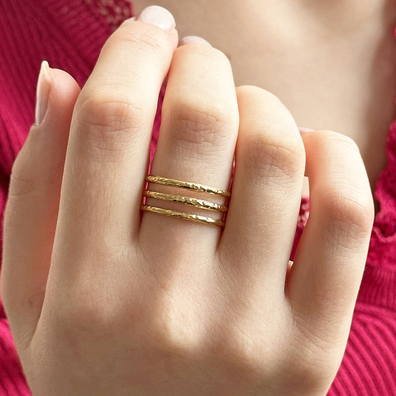 Image shows model in pink top wearing triple band textured ring