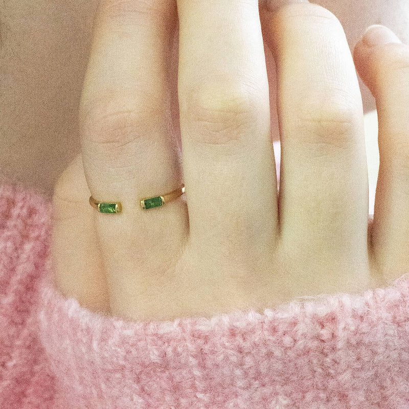 Model wears a single May Emerald Baguette Birthstone Stacking Ring.