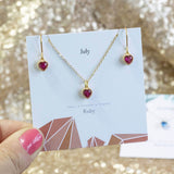 Model holds Birthstone Hearts Jewellery Set in July Ruby birthstone on a 'July