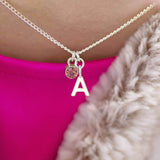 Model wears Child's Silver Plated Initial and Birthstone Necklace with October Rose birthstone and the initial 
