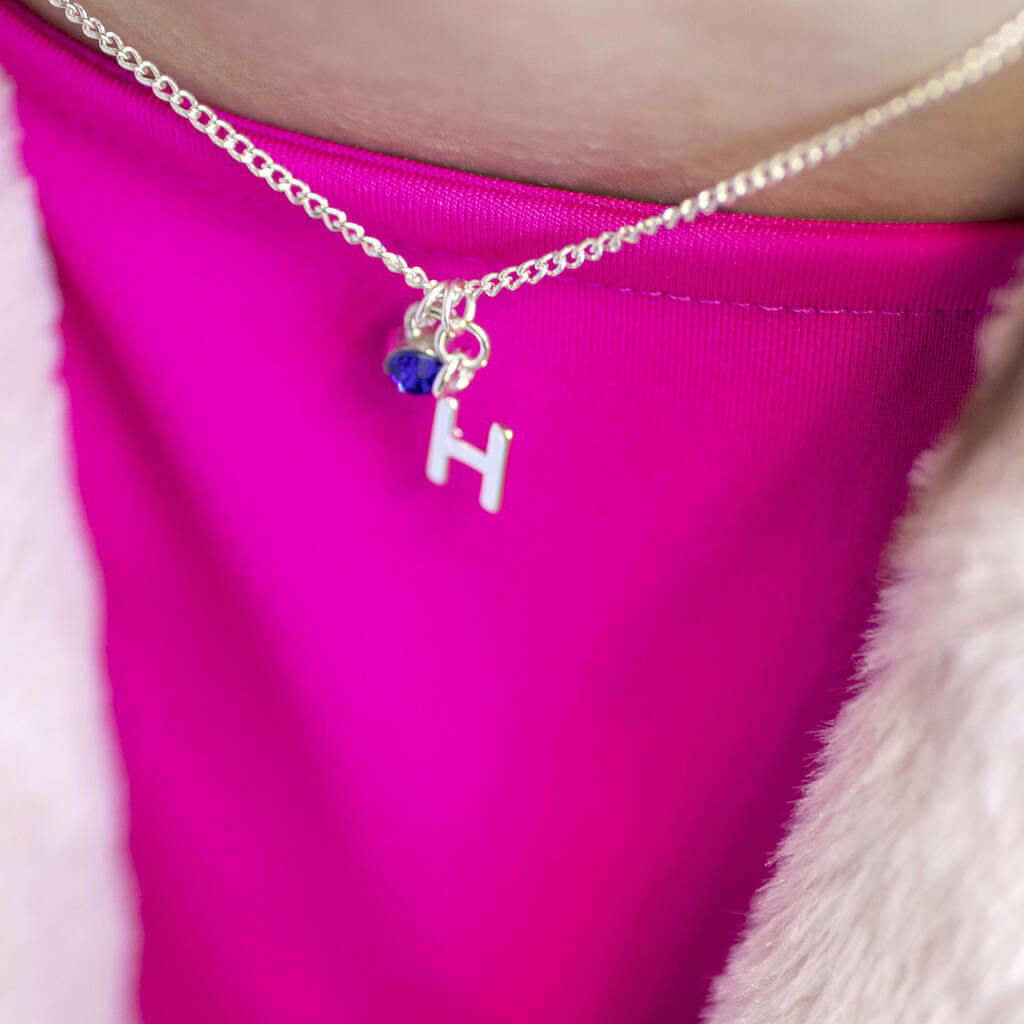 Model wears Child's Silver Plated Initial and Birthstone Necklace with the letter "H" and September birthstone.