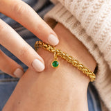 Gold plated rope chain bracelet with an emerald green birthstone charm, bold everyday jewellery with colour.