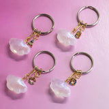 Image shows four Cloud Keyring with Rainbow Initials on a pink backdrop.