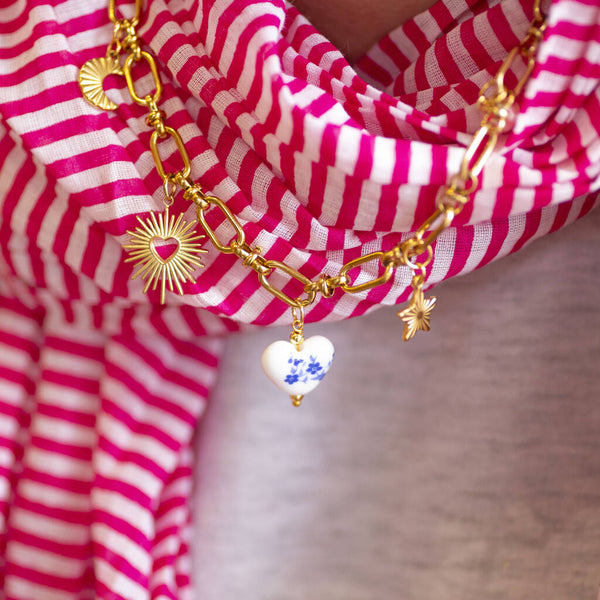 Create your own charm necklace with 16 symbolic gold charms including hearts, pearl, star and moon