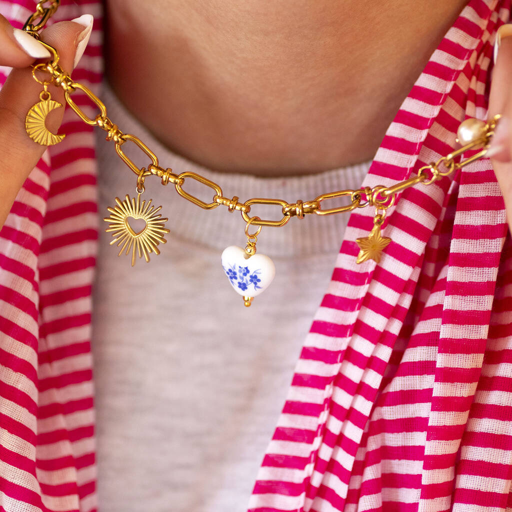 Personalised gold charm necklace with chunky chain and custom selected charms arranged in order