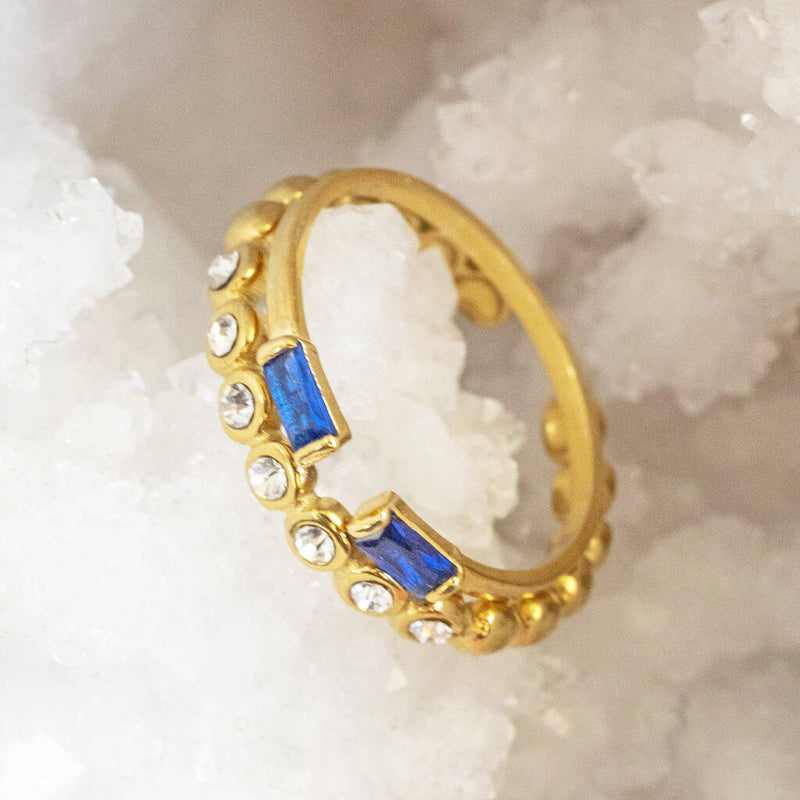 Image shows stackable crystal band ring stacked with the September Sapphire baguette birthstone ring