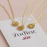 Gold crystal zodiac necklaces on branded card, celestial pendant jewellery for everyday styling and layering