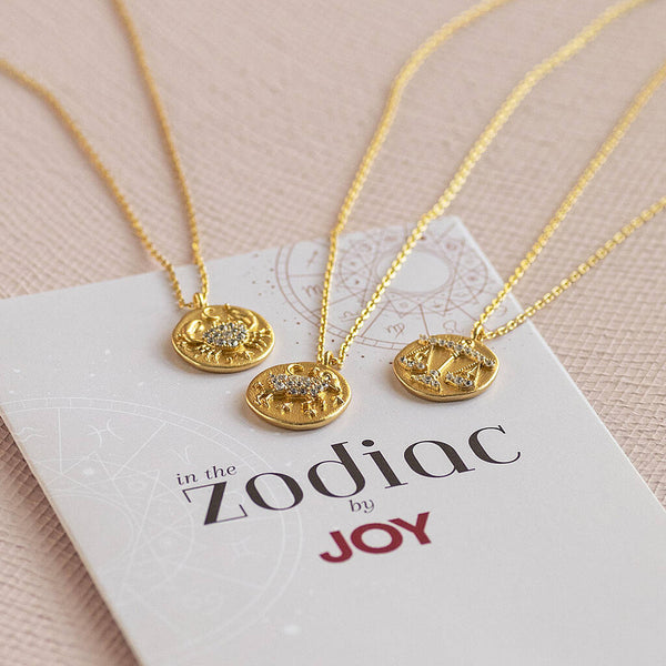 Gold crystal zodiac necklaces on branded card, celestial pendant jewellery for everyday styling and layering