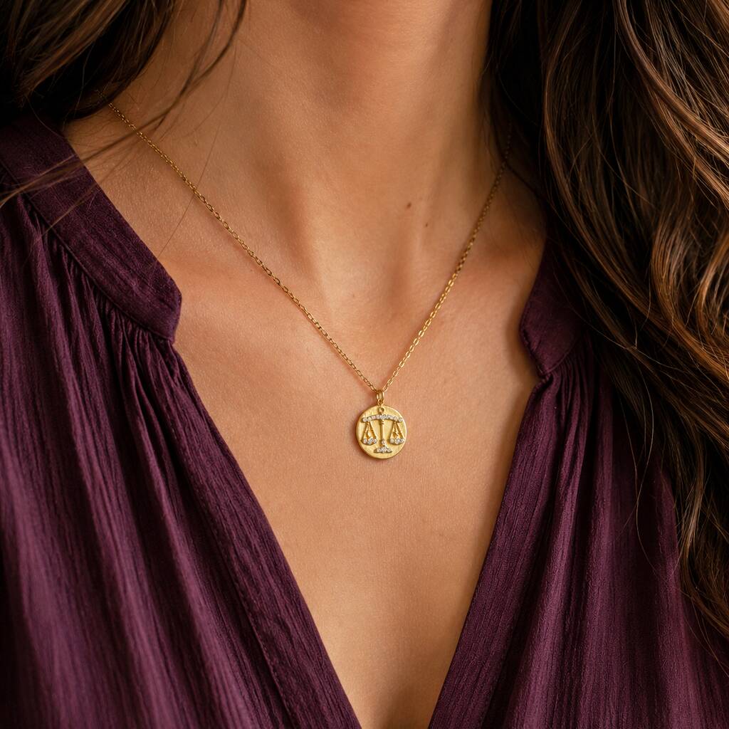 Gold crystal Libra coin necklace styled with plum blouse, celestial layering jewellery with zodiac charm
