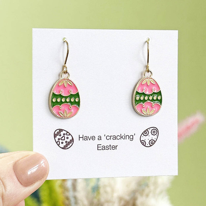 pink with green border enamel Easter egg charms on gold plated earring hooks displayed on a have a 'cracking' Easter sentiment card 