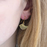 Image shows a woman wearing silver love bird earrings