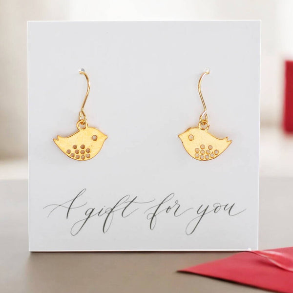 image shows a pair of gold love bird earrings presented on A gift for you sentiment card.