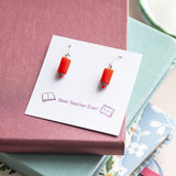 Red pencil drop earrings on a keepsake display card, colourful novelty jewellery with a playful finish.