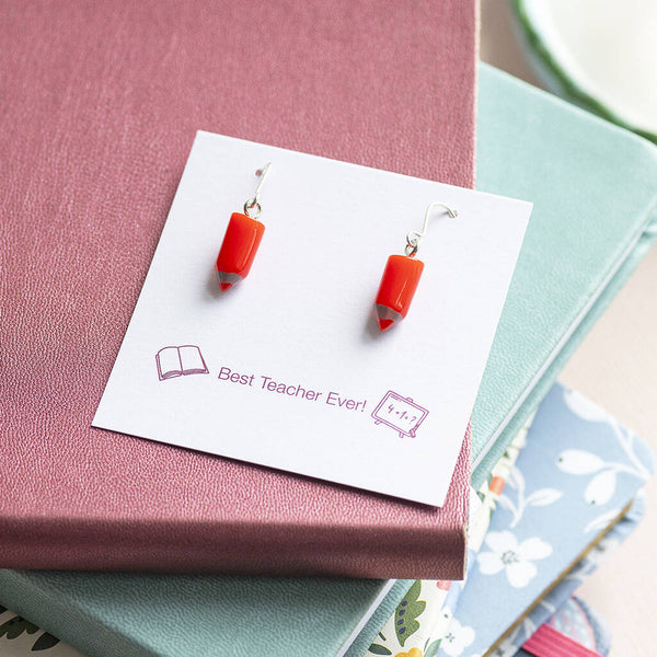 Red pencil drop earrings on a keepsake display card, colourful novelty jewellery with a playful finish.