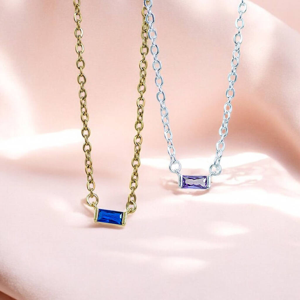 Dainty baguette birthstone necklaces in gold and silver tones with blue and purple stones for colourful everyday styling.