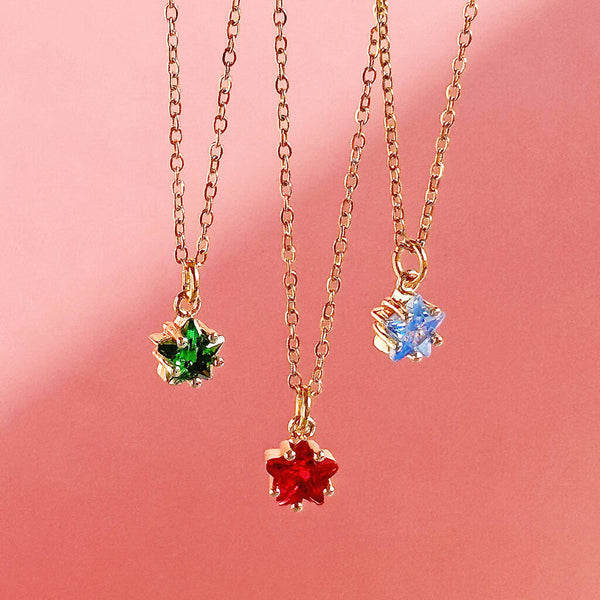 Image shows emerald, ruby and aquamarine dainty birthstone star necklaces