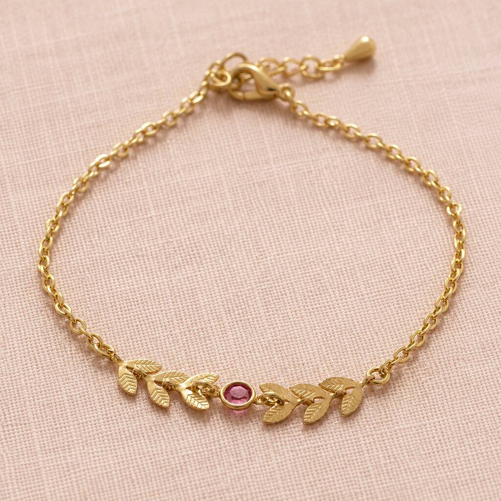 Gold plated vine bracelet with a pink birthstone crystal on a delicate chain, perfect for everyday styling