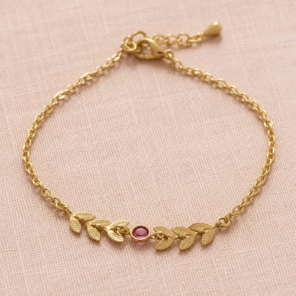 Gold plated vine bracelet with a pink birthstone crystal on a delicate chain, perfect for everyday styling