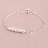 Sterling silver bracelet with four Swarovski pearls, refined minimalist jewellery with a classic finish.