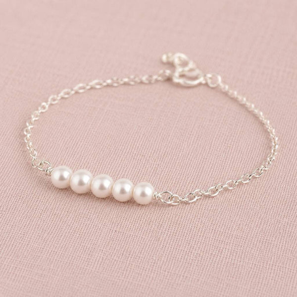 Sterling silver bracelet with four Swarovski pearls, refined minimalist jewellery with a classic finish.