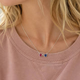 Silver double heart birthstone necklace with pink and blue crystal charms, perfect for layering jewellery