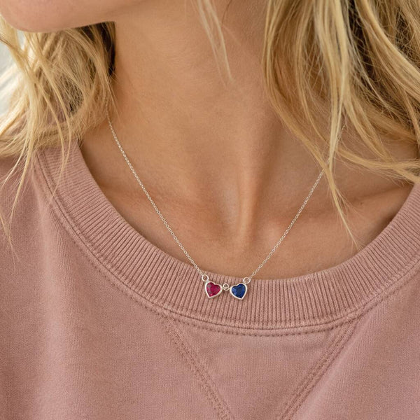 Silver double heart birthstone necklace with pink and blue crystal charms, perfect for layering jewellery