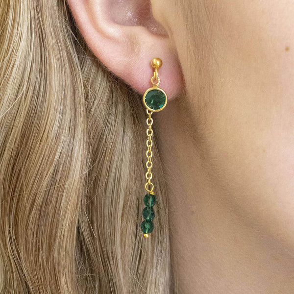 Model wears Double Drop Birthstone Chain Earrings in May Emerald.