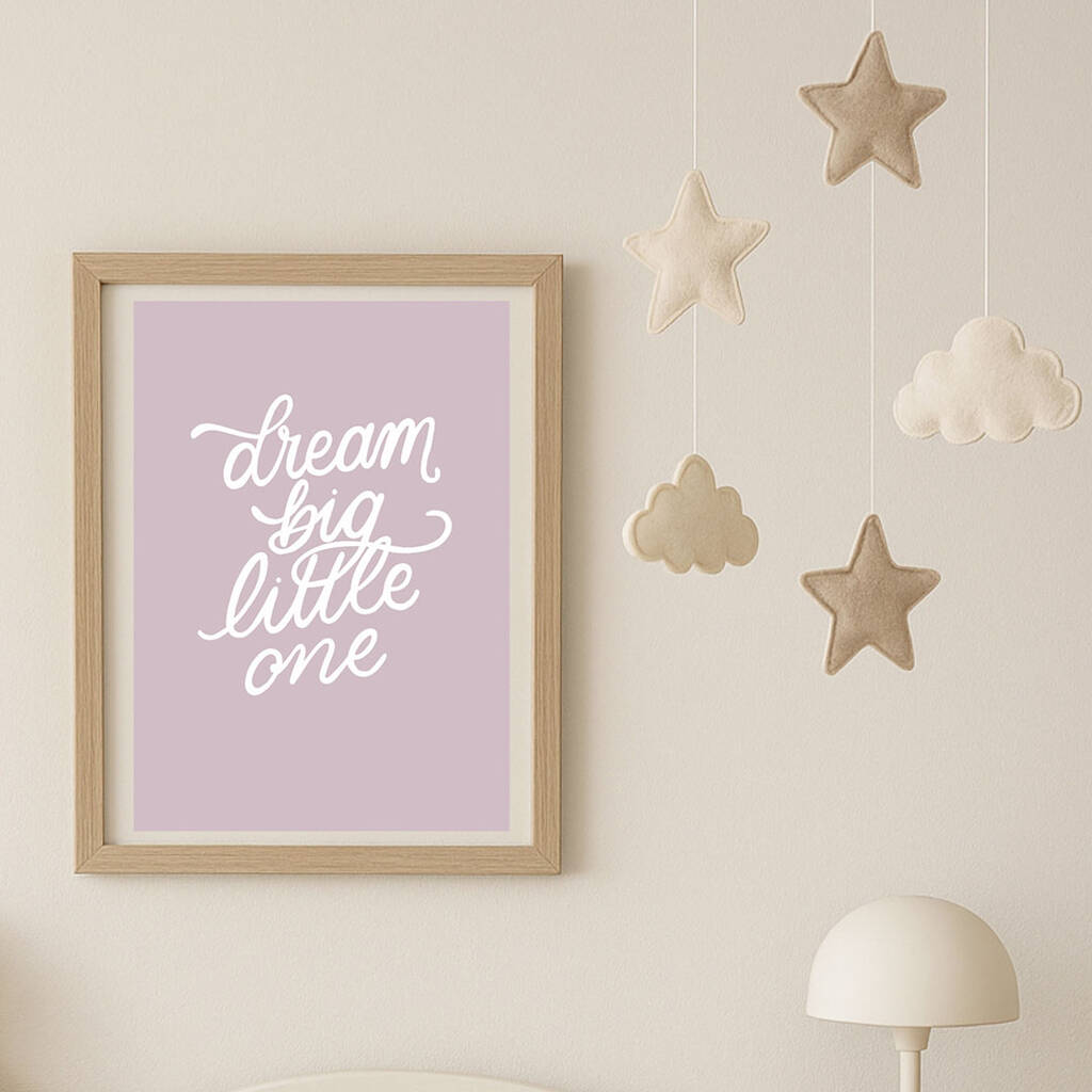 Inspirational nursery wall art print with Dream Big Little One wording, framed on patterned wall