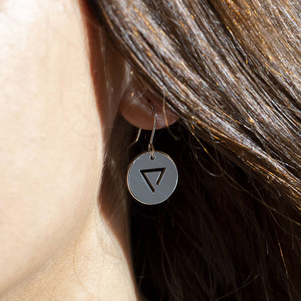 image show silver water element earring worn on a women's earlobe