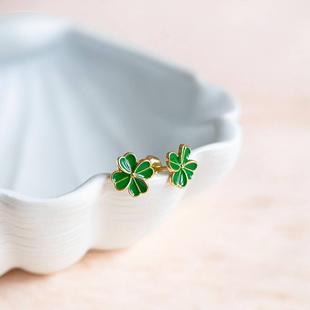 Green enamel four leaf clover stud earrings shown in gold.