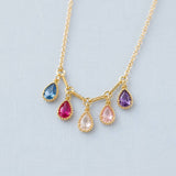 Close-up gold plated necklace with teardrop crystal drops in mixed colours, creating a delicate personalised look