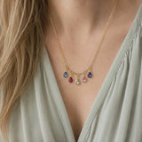 Gold plated necklace with colourful teardrop birthstone charms, styled as a delicate statement layering piece