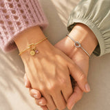 Gold and silver friendship knot bangles with birthstone charms, stylish personalised jewellery set