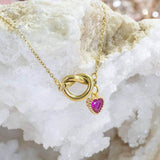 Image shows Friendship Knot Necklace with Heart Birthstone on a white backdrop.