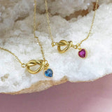 Image shows two Friendship Knot Necklace with Heart Birthstones on a white backdrop.