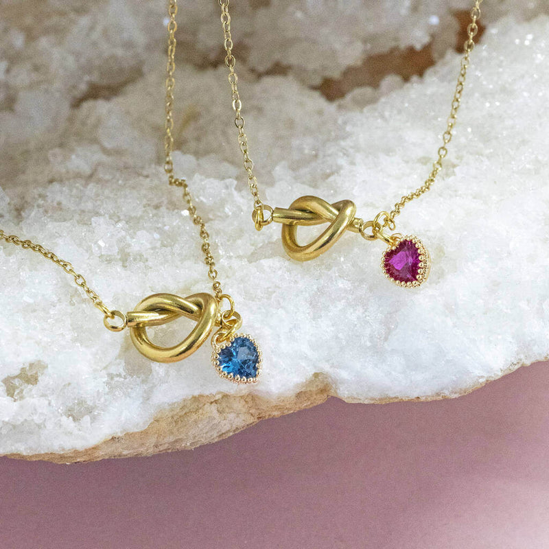 Image shows two Friendship Knot Necklace with Heart Birthstones on a white backdrop.