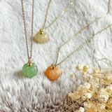 Image shows pumpkin necklaces on an autmnal styles background