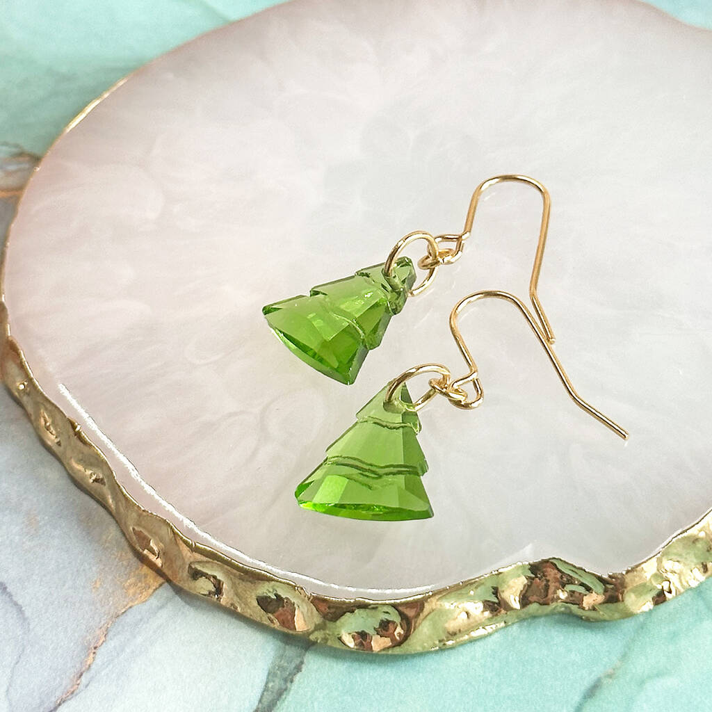 Image show Christmas tree earrings on a marble trinket dish